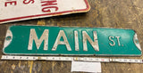 Vtg Embossed Main Street sign Tin Auto Truck Oil Gas Man Cave GArage Decor 24"