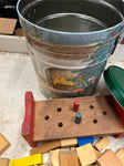 Tin container full of vintage wooden blocks and shapes childrens toys