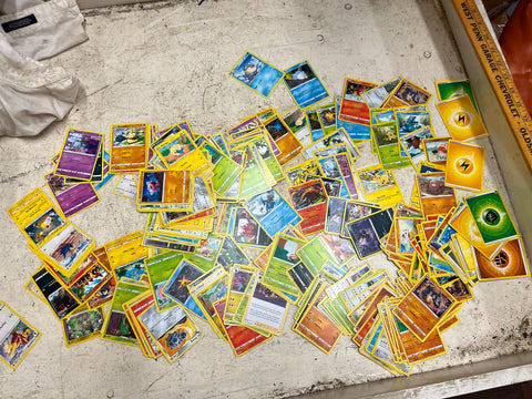 Bag full of 70+ Pokémon cards various generations, types, and colors
